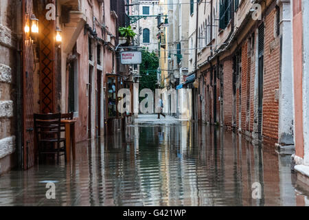 Venice, Italy. 15th June, 2016. A woman walks in the streets during the high water on June 15, 2016 in Venice, Italy. The high water in this period is exceptional, and it is a surprise for citizen and tourists.  Credit:  Simone Padovani /Awakening/Alamy Live News Stock Photo