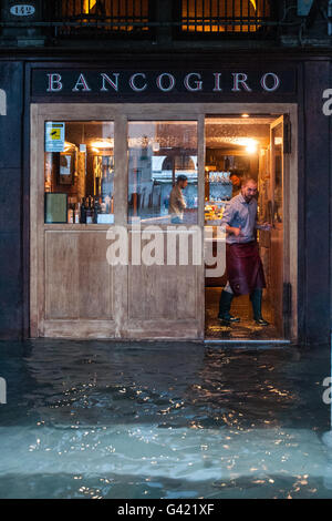 Venice, Italy. 15th June, 2016. A waiter works during the high water on June 15, 2016 in Venice, Italy. The high water in this period is exceptional, and it is a surprise for citizen and tourists.  Credit:  Simone Padovani /Awakening/Alamy Live News Stock Photo