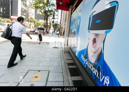 Pedestrians walk past the Sony Building in Ginza on June 17, 2016, Tokyo, Japan. Sony announced plans to tear down its Ginza landmark building and replace it with a park whose concept will be similar to the stairs in New York's Time Square. On Monday, the company said that demolition would start in spring 2017 and be concluded by summer 2018. Sony's public park would then operate until after the Olympic Games in 2020. Kazoo Hirai, President and CEO of Sony, said that after the Games, Sony would construct a new building on the land. The current Sony Building was constructed in 1966 and attracts Stock Photo