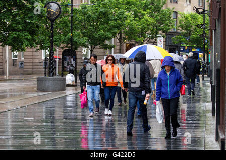 Dundee, Tayside, Scotland, UK. June 17th 2016. UK Weather: Daily life continues despite a week of constant rain in Dundee. Raincoats and brollies as people shelter from the cold and wet June weather. Credit: Dundee Photographics / Alamy Live News