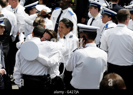 Paris, France. 17th June, 2016. Colleagues react during the national homage ceremony in honor of the police officer and his partner stabbed to death by a man who claimed allegiance to the Islamic State (IS) group, at the Versailles, in Paris, France, June 17, 2016. French President Francois Hollande, Prime Minister Manuel Valls and Interior Minister Bernard Cazeneuve attended the ceremony. Credit:  Theo Duval/Xinhua/Alamy Live News Stock Photo