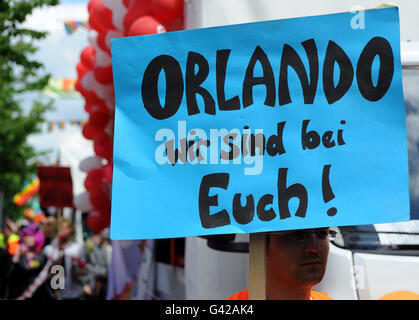 Oldenburg, Germany. 18th June, 2016. Thousands of participants move through the city center during Christopher Street Day in Oldenburg, Germany, 18 June 2016. A sign written with 'Orlando! We're with you!' announces solidarity with the victims of the attack in Orlando, Florida, USA. Photo: INGO WAGNER/dpa/Alamy Live News Stock Photo