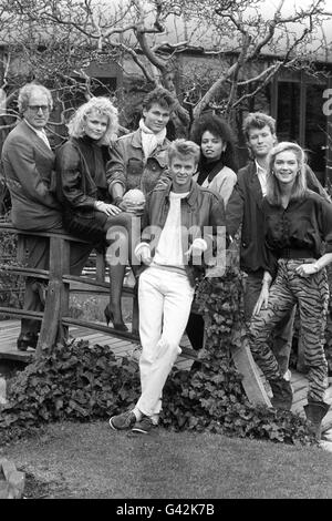 Norwegian Pop group A-Ha are recording the title song for the James Bond film 'The Living Daylights', starring Timothy Dalton. Members of the Bond team in London are Composer John Barry (glasses), bond girls Karen Seeberg (sitting), Femi (dark hair) and Trishi (right). A-Ha members are Morten Harket (scarf), Pal Waaktaar (front) and Magne Furuholmen (2nd r). Stock Photo
