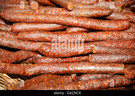 Hungarian homemade smoked sausages with red paprika at rural market Stock Photo