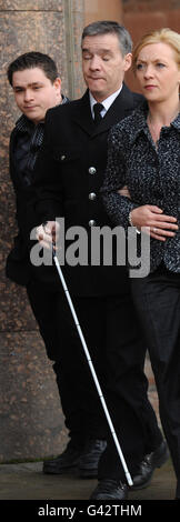 Police officer David Rathband arrives with his wife Katherine and son ...