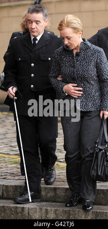 Police officer David Rathband arrives with his wife Katherine and son ...