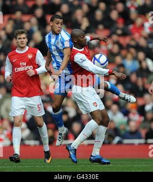 Arsenal's Vassiriki Diaby (right) and Huddersfield Town's Lee Peltier battle for the ball Stock Photo