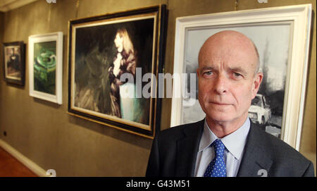 Former Head of MI6 Sir John Scarlett with paintings from ' A year with MI6' at the Mount Street Gallery in London. Stock Photo