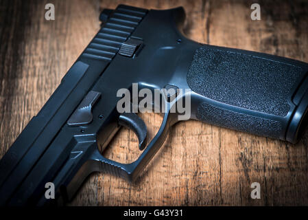 a Sig P250 semi-automatic pistol on wooden surface Stock Photo