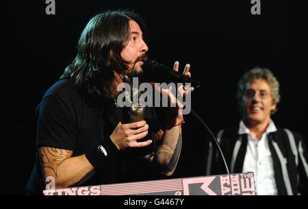 Dave Grohl (left) collects the God Like Genius Award from Roger Daltrey (right) on stage during the 2011 NME Awards at the O2 Academy Brixton, London Stock Photo