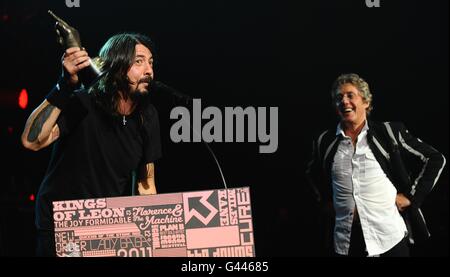 Dave Grohl (left) collects the God Like Genius Award from Roger Daltrey (right) on stage during the 2011 NME Awards at the O2 Academy Brixton, London Stock Photo