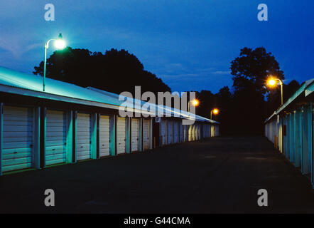 Night view of garage like rental storage units lined up in a row Stock Photo
