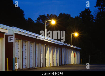 Night view of garage like rental storage units lined up in a row Stock Photo