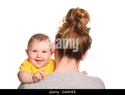 Mother carrying baby girl looking over shoulder cutout Stock Photo