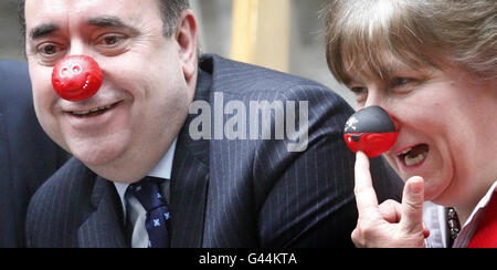 First Minister Alex Salmond (left) and Annabel Goldie Leader of the Scottish Conservative Party (right) wear red noses in support of comic relief at The Scottish Parliament in Edinburgh. Stock Photo