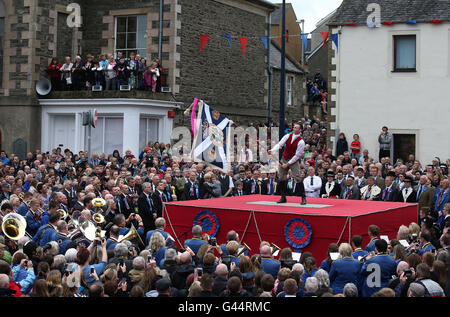 Royal Standard Bearer Rory J. Monks waves the burgh flag during a ceremony in the Selkirk's Market Place during the Selkirk Common Riding, a centuries-old tradition in the royal burgh in the Scottish Borders. Stock Photo