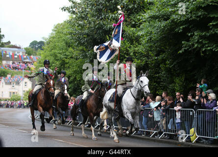 Royal Standard Bearer Rory J. Monks (right) leads riders taking part in the Selkirk Common Riding, a centuries-old tradition in the royal burgh of Selkirk in the Scottish Borders. Stock Photo