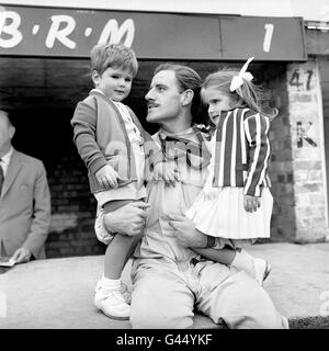 Current world champion Graham Hill photographed in the pits with son Damon and daughter Brigitte during practice for tomorrow's British Grand Prix at Silverstone. Stock Photo