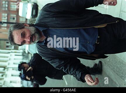 Soccer legend George Best emerges from his London flat today (Fri) following reports that he had beaten his young wife Alex. The 50-year-old denied reports that his 25-year-old wife had gone to or called the police following a drinking spree to celebrate her 25th birthday. See PA story POLICE Best. Photo by Tim Dickinson/PA. Stock Photo