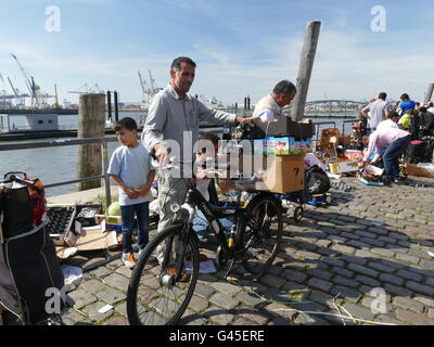 Europe Germany Hamburg Hamburger Fischmarkt outdoor. Immigrants and Afganis picking up rest of vegetable from Mobil truck shop b Stock Photo