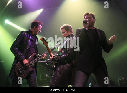 (Left to right) John Taylor on bass, Dom Brown on guitar and Simon Le Bon of Duran Duran performing on stage at the O2 Shepherds Bush Empire, London. Stock Photo