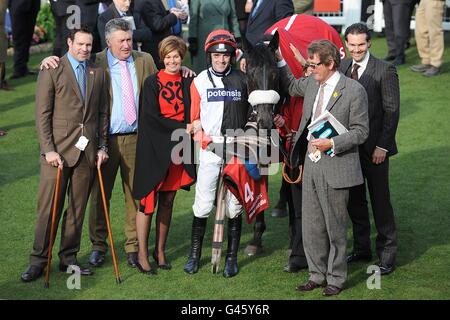 The winning party including jockey Ruby Walsh (centre), trainer Paul Nicholls (second left) with owners, the Stewart family after Big Buck's after victory in the Ladbrokes World Hurdle on St Patrick's Day, during the Cheltenham Festival Stock Photo
