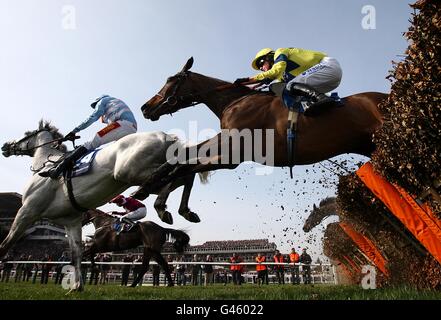 Horse Racing - 2011 Cheltenham Festival - Day Three. Michael Flips ridden by Nick Scholfield (right) jumps a fence on St Patrick's Day, during the Cheltenham Festival. Stock Photo