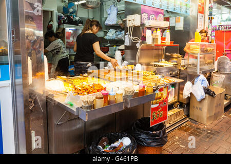 Hong Kong SAR, China - July 26, 2015: A street vendor selling popular snacks at Fa Yuen Street market in Kowloon. Stock Photo