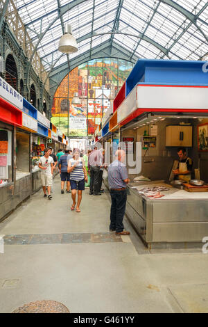 Interior of Atarazanas, covered Market with closed vendor kiosks in Malaga, Andalusia, Spain.