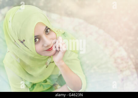Beautiful young arab woman posing outdoors in a headscarf. Attractive 