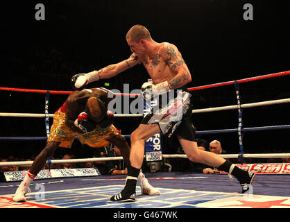 Ricky Burns (right) in action against Joseph Lareya during the WBO Super-Featherwight bout at the Braehead Arena, Glasgow. Stock Photo