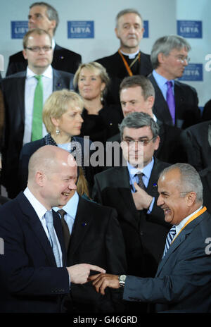 British Foreign Secretary William Hague (left) shares a joke with United Nations Special Envoy for Libya Abdelilah Mohamed Al Khatib (right) during a family photograph at the start of the Libya Conference in London.