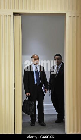 Guma El-Gamaty (L), British co-ordinator for the rebel interim National Council of Libya, arrives with its head of media relations, Mahmoud Shammam, for a news conference at the Foreign & Commonwealth Office in London. Stock Photo