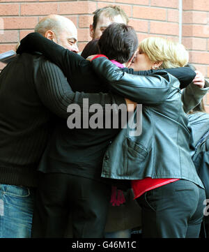 Kim Smith (centre, back to camera) is hugged by family outside Birmingham Crown Court, where Christopher Grady was convicted of murdering their five-year-old daughter Gabrielle after he drove his car into a freezing river with her on the front passenger seat. Stock Photo