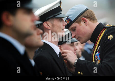 Prince Harry, in his role as Commodore-In-Chief, Small Ships and Diving, presents medals to members of the First and Second Mine Countermeasures Squadrons (MCM1 and MCM2) at Portsmouth Naval Base, Hampshire, to mark their service in Iraq. Stock Photo