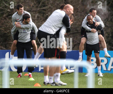 Wales' Gareth Bale (left) on the back of Joe Ledley with and Danny Gabbidon who holds up Neil Eardley (right) during the training session at the Vale Hotel, Hensol. Stock Photo