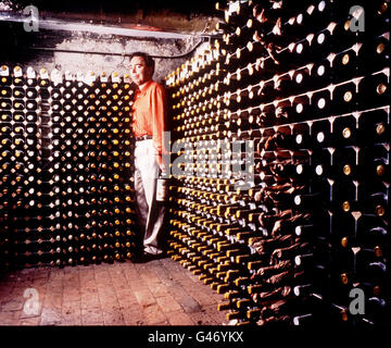 Sir Andrew Lloyd Webber in the cellar of his English country house in Berkshire. Sir Andrew instructed Sotheby's, London to sell a major part of his lifelong collection of fine wines from his cellars in England and South of France. The sale of more than 18,000 bottles was estimated to raise in excess of 2 million and was to be held at Sotheby's in London . Stock Photo