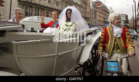 Lookie likies of Queen Elizabeth II, Kate Middleton and Prince William arrive at Waterstones, Picadilly, London, for the launch of a new book 'Kate & Wills up the Aisle' by Alison Jackson. Stock Photo