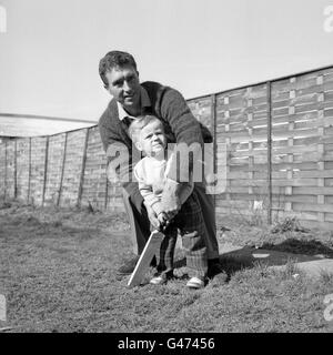 England and Middlesex cricketer Fred Titmus, at home in Hatfield, playing with his two year old son, Mark. Stock Photo