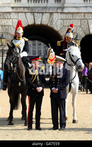 Captain Anton Lin from Blues and Royals of the Household Cavalry (left) and Captain Le Blay from the French Garde Republicaine (right) pose on horseback as Major General Cubitt GOC (2nd left) talks with French Attache Admiral Charles-Edouard de Coriolis (2nd right) in Horse Guards, London where it was announced that French armed forces will join British servicemen in the annual Royal Tattoo in the grounds of Windsor Castle in May. Stock Photo