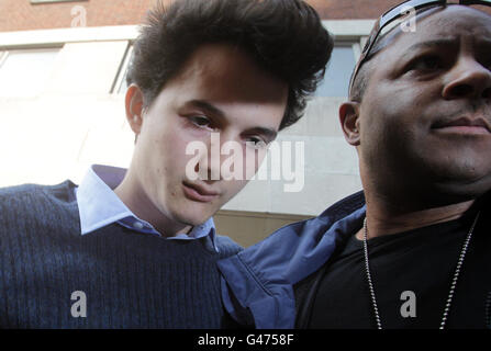 Charlie Gilmour, the son of Pink Floyd guitarist David Gilmour, is lead away from Westminster Magistrates Court after appearing today over the attack on a royal convoy of cars during a student fees riot. Stock Photo