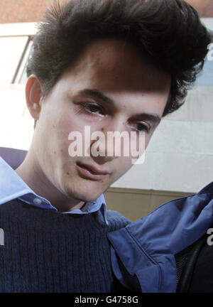 Charlie Gilmour, the son of Pink Floyd guitarist David Gilmour, is lead away from Westminster Magistrates Court after appearing today over the attack on a royal convoy of cars during a student fees riot. Stock Photo