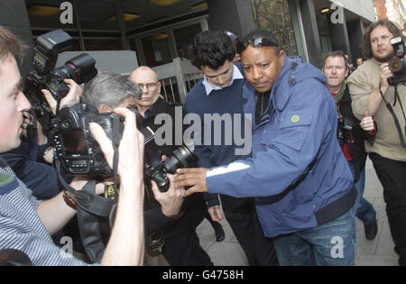 Charlie Gilmour, the son of Pink Floyd guitarist David Gilmour, is lead away from Westminster Magistrates Court after appearing today over the attack on a royal convoy of cars during a student fees riot. Stock Photo