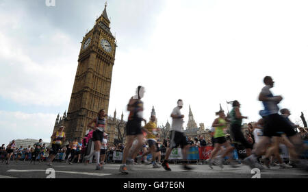 Competitors run past the Houses of Parliament during the 31st Virgin London Marathon in London. Stock Photo