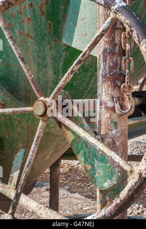 Handwheel on an old green concrete bucket Stock Photo