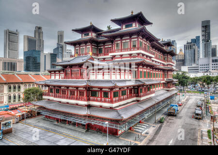 HDR rendering of the Buddha Toothe Relic Temple in Singapore's Chinatown, with the city's skyscraper business district in the ba Stock Photo