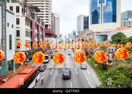 Singapore  - January 17, 2016: Colorful decorations hang over the streets in Chinatown to celebrate Chinese New Year. Stock Photo