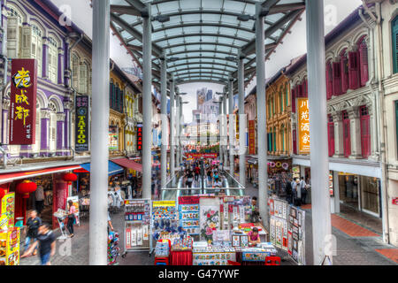 Singapore- December 15, 2014: People strolling along Chinatown's Pagoda Street where low-rise Baroque-Victorian style buildings. Stock Photo