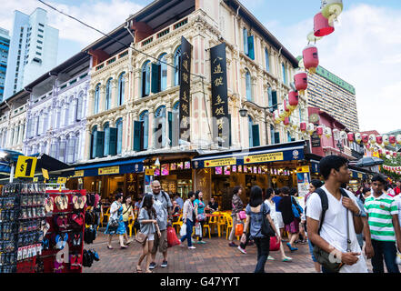 Singapore, Singapore - December 15, 2014: Shoppers and diners visit Chinatown for bargain souvenirs and authentic local food. Stock Photo