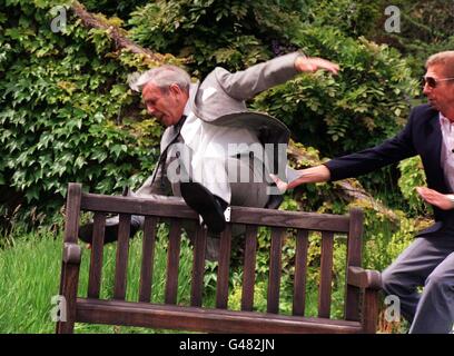 Comic legend Norman Wisdom up to his old tricks as he falls of a bench, during today's (Sunday) unveiling of a plaque in his honour in the British Comedy Society's Hall of Fame, at Pinewood studios. He is the first comedian to receive the honour to mark 50 years in showbusiness. See PA Story SHOWBIZ Wisdom. Photo by Tony Harris. Stock Photo